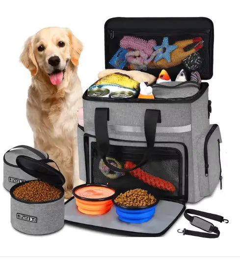 Dog with a gray pet travel bag containing food, toys, and supplies on a white background